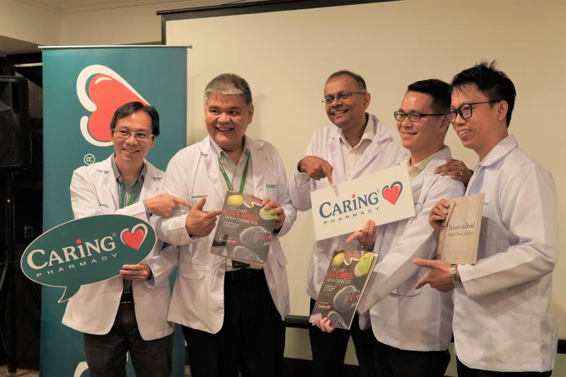 Chong Yeow Siang (second from left), and Dato’ Dr Rajen Manicka (centre) with CARiNG Pharmacy staff at the launch of the Live