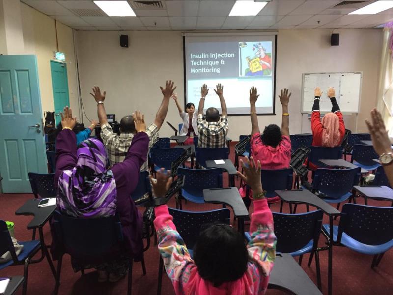 Lim conducting an exercise session prior to a talk at a group patient programme.